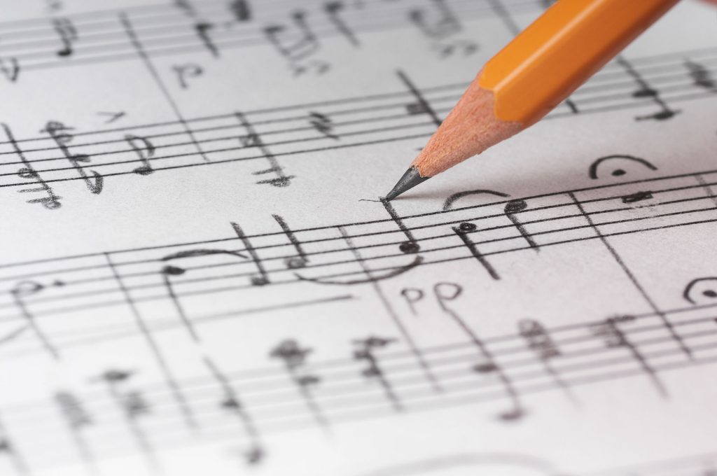 Writing music notes with a graphite pencil